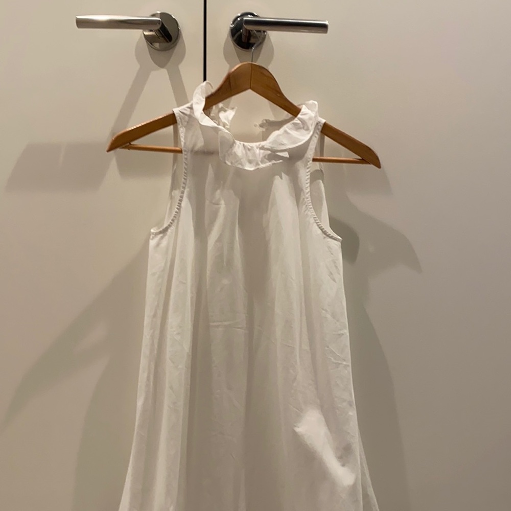 White sleeveless dress with ruffle neck
